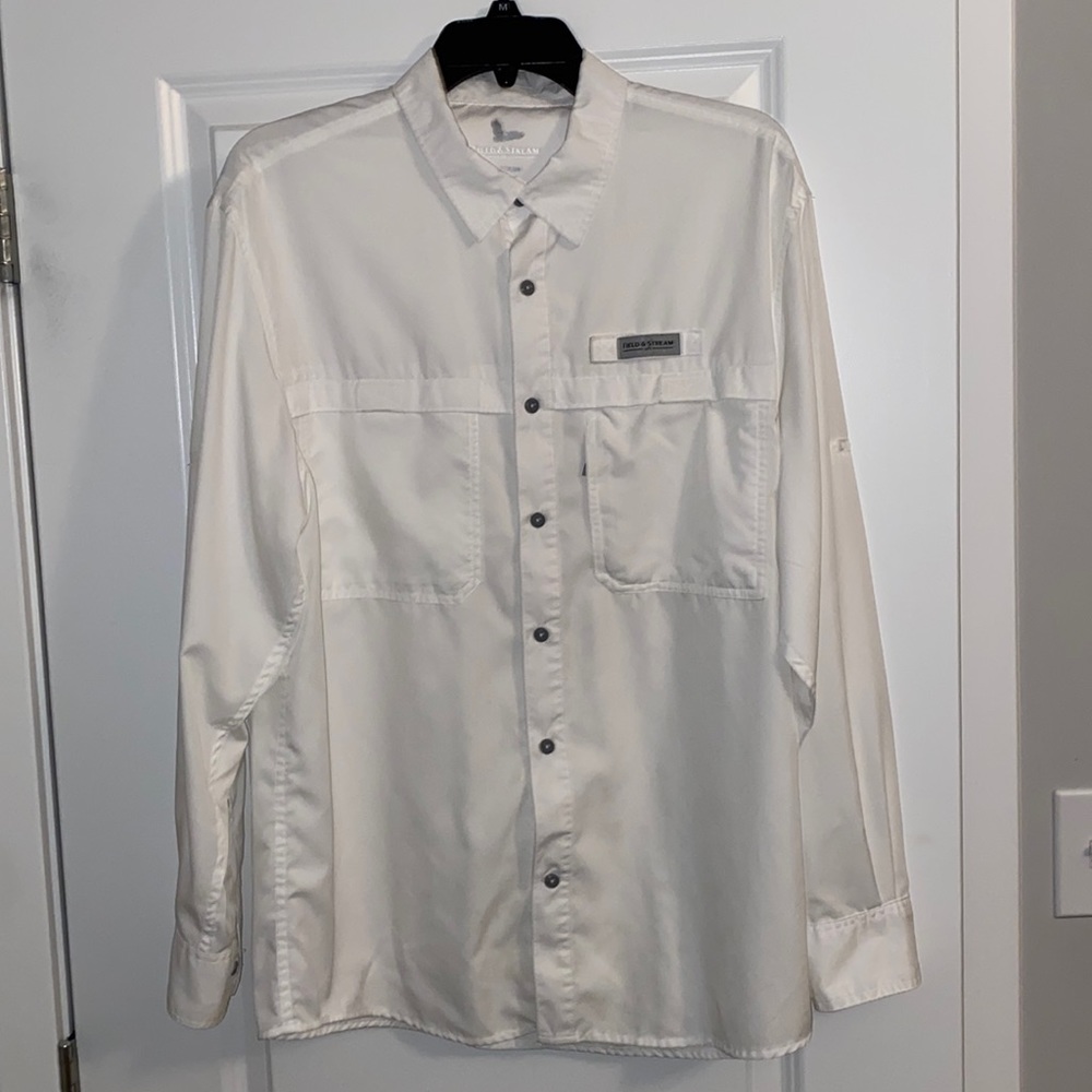 Size medium field and stream fishing shirt. Small ink stain on the left sleeve.